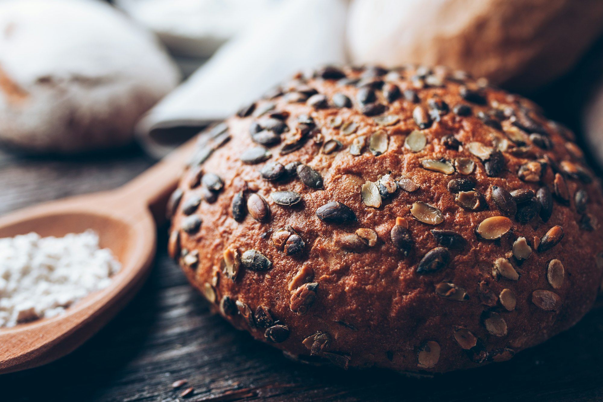 Delicious fresh bread on wooden background