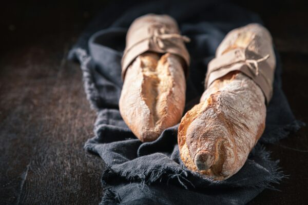 Brown baguettes for healthy breakfast. Country kitchen or bakery.